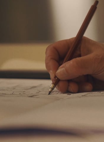 Person writing with pencil
